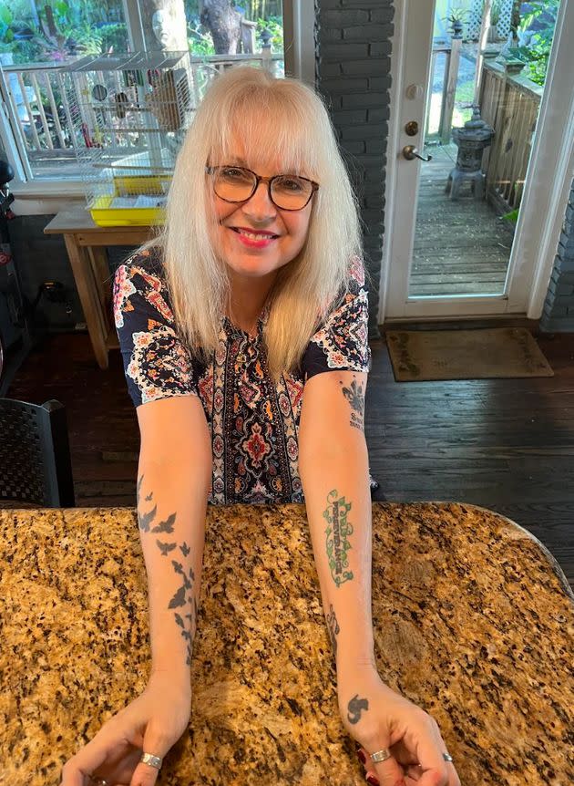 The author showing off some of her nine tattoos. (Photo: Courtesy of Marcia Kester Doyle)