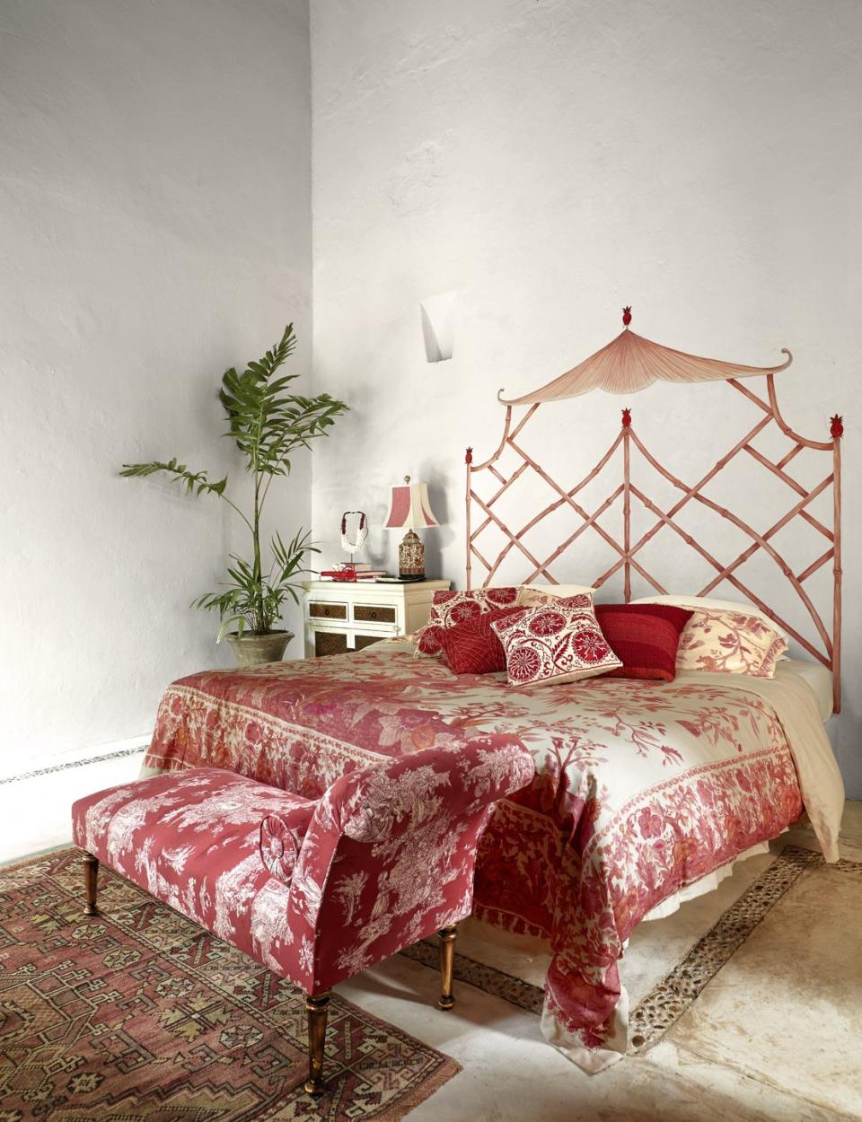 boho bedroom with red chaise longue and uzbek print pillows