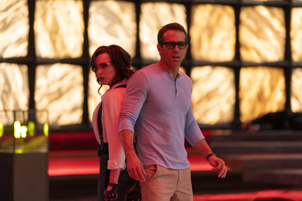 This image released by Disney shows Jodie Comer as Molotov Girl, left, and Ryan Reynolds as Guy in a scene from "Free Guy." (Alan Markfield/Disney-Twentieth Century Fox via AP)