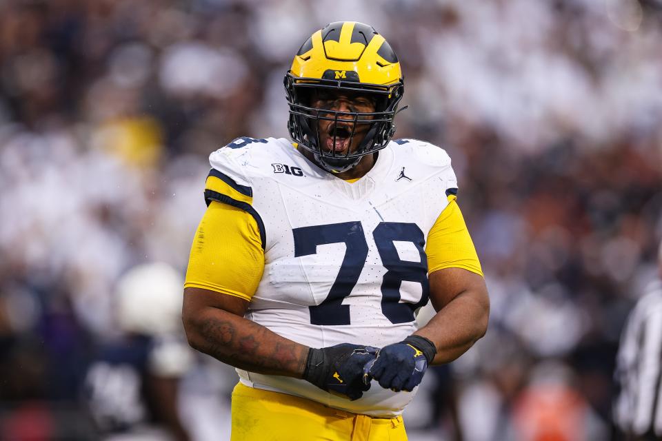 Kenneth Grant of the Michigan Wolverines celebrates after a defensive play against the Penn State Nittany Lions during the second half at Beaver Stadium on November 11, 2023 in State College, Pennsylvania.