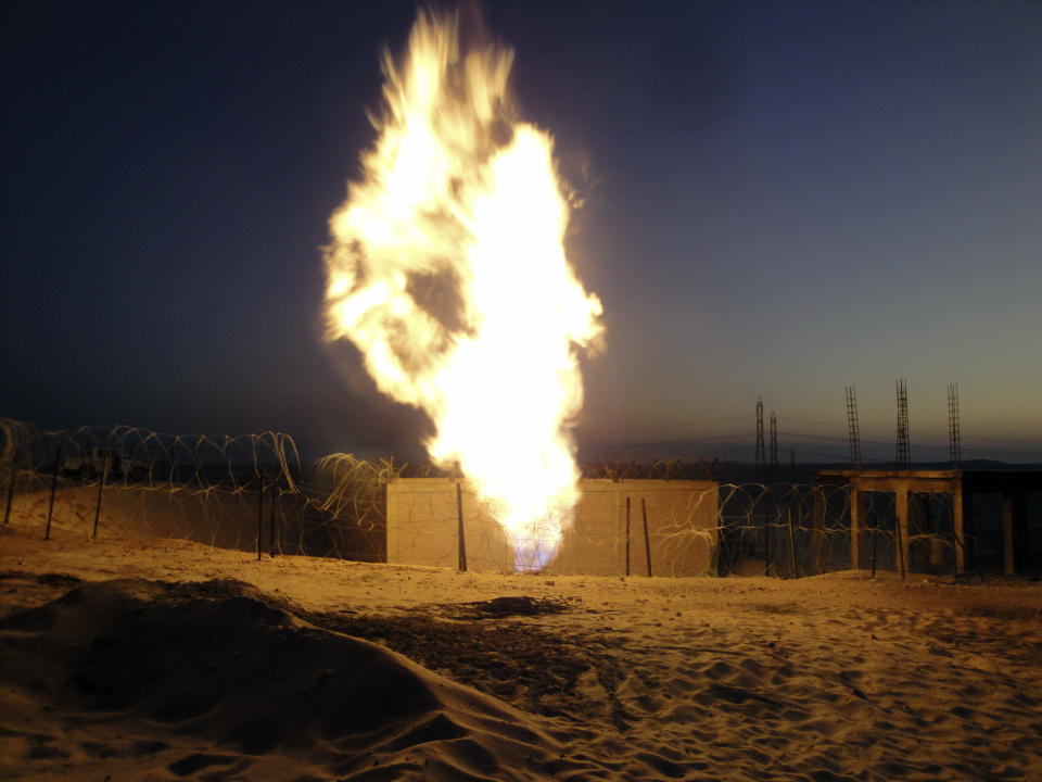 FILE - In this Monday, July 4, 2011 file photo, flames rise after an explosion near the town of El-Arish, Egypt, 30 miles (50 kilometers) from the border with Israel after unidentified assailants blew up the Egyptian pipeline that carries gas to Israel and Jordan, starting a fire and disrupting the flow of the gas, security officials said. Israel's prime minister is playing down the Egyptian decision to halt gas exports to Israel. Benjamin Netanyahu said Monday, April 23, 2012, that the cutoff was the result of a "business dispute" between Israeli and Egyptian companies.(AP Photo, File)