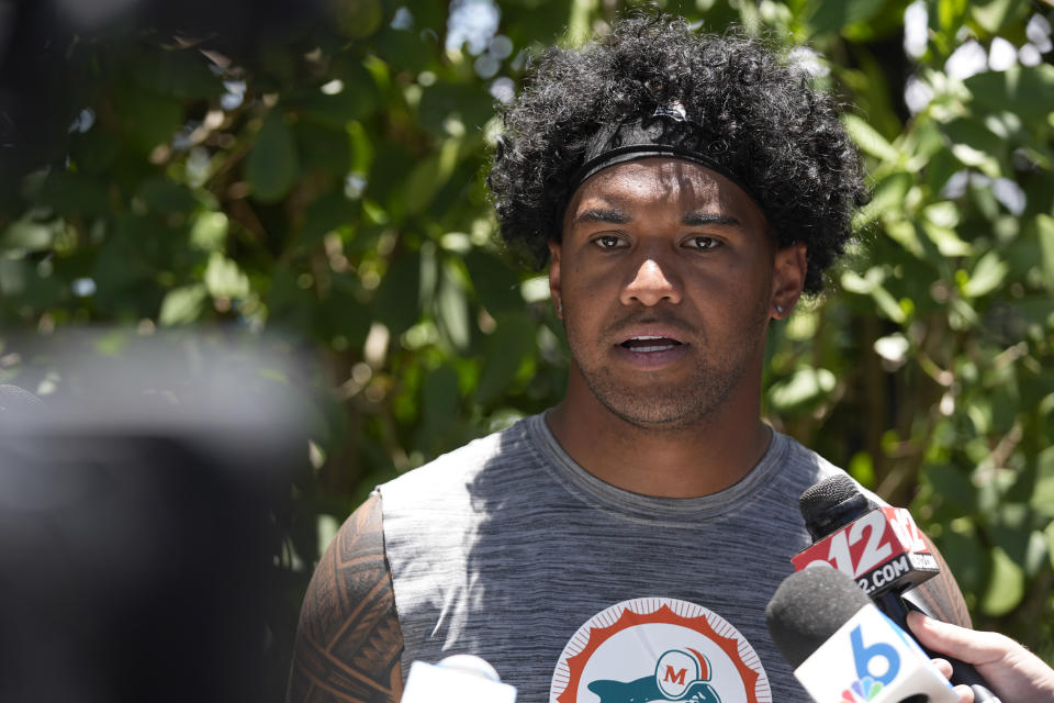 Miami Dolphins quarterback Tua Tagovailoa speaks to members of the media after an NFL football practice at the team's practice facility, Tuesday, June 4, 2024, in Miami Gardens, Fla. (AP Photo/Wilfredo Lee)