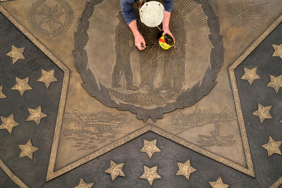 Workers from the Norman foundry The Crucible put the finishing touches on the new Seal of the State of Oklahoma on the ground floor of the Capitol as part of the ongoing Capitol Restoration Project, Monday, March 22, 2021.