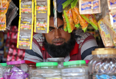 A man from the Rohingya community looks on as he sits inside his shop at a camp on the outskirts of Jammu October 5, 2018. REUTERS/Mukesh Gupta