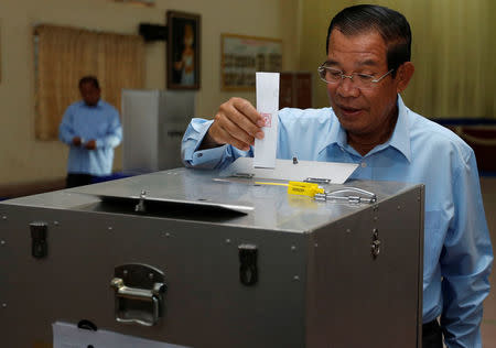 Cambodia's Prime Minister and President of the Cambodian People's Party (CPP), Hun Sen drops a ballot into a box during a senate election in Takhmao, Kandal province, Cambodia February 25, 2018. REUTERS/Samrang Pring