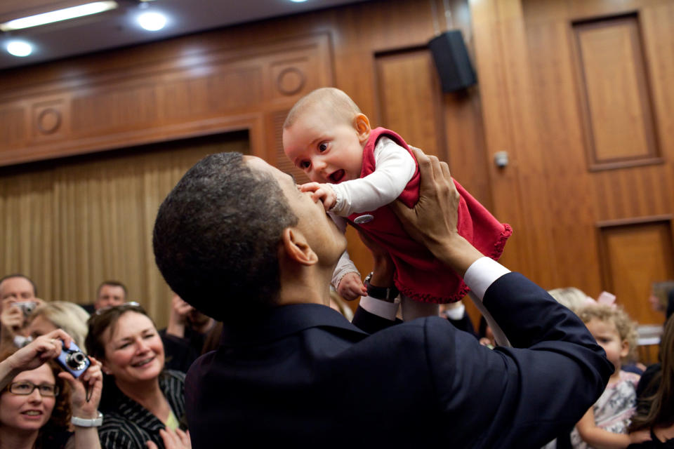 President Barack Obama lifts up a baby during the U.S. Embassy greeting at a Prague hotel on April 4, 2009 in Prague, Czech Republic. (Pete Souza/White House via Getty Images)