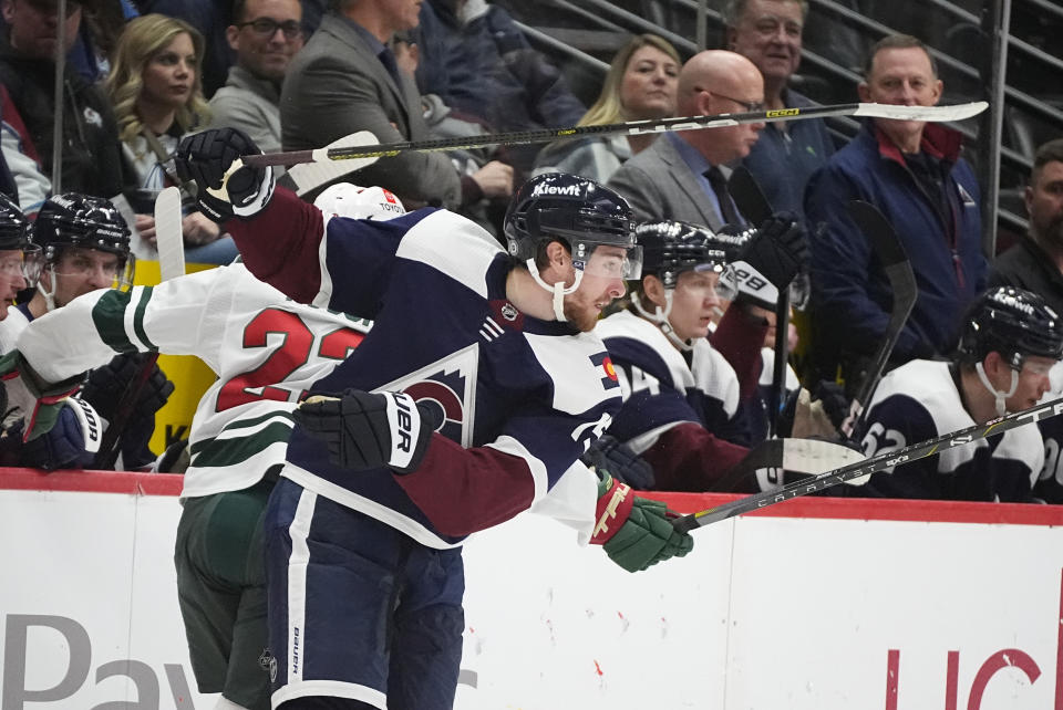 Newly-acquired Colorado Avalanche left wing Yakov Trenin, front, avoids a check from Minnesota Wild center Marco Rossi in the second period of an NHL hockey game Friday, March 8, 2024, in Denver. (AP Photo/David Zalubowski)