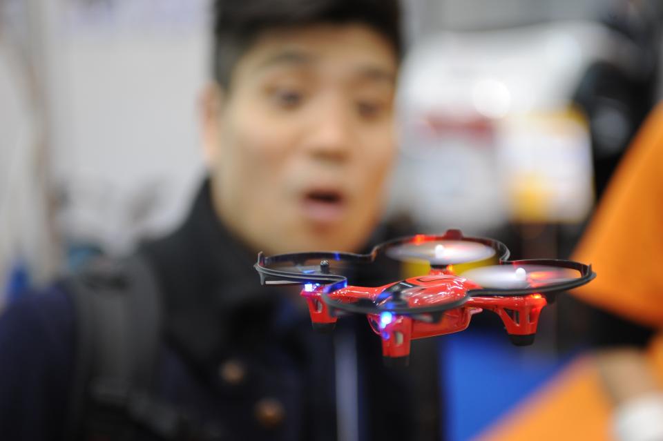 A miniature drone in flight at the International Robot Exhibition.