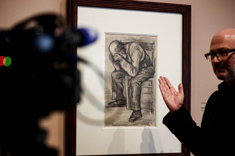 A man gives explanations in front of a newly discovered work by Vincent van Gogh "Study for "Worn out" from 1882, displayed at the Van Gogh Museum's in Amsterdam on September 16, 2021.