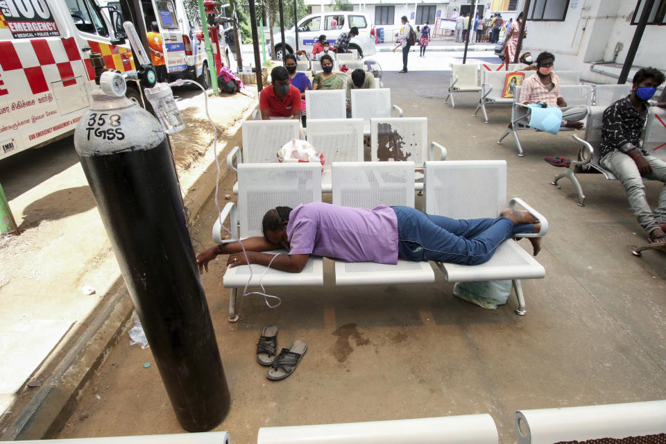 A COVID-19 patient on oxygen support waiting for admission lies on chairs outside the Tamil Nadu Government Multi Super Speciality Hospital in Chennai, India, Monday, May 17, 2021. Source:  Associated Press