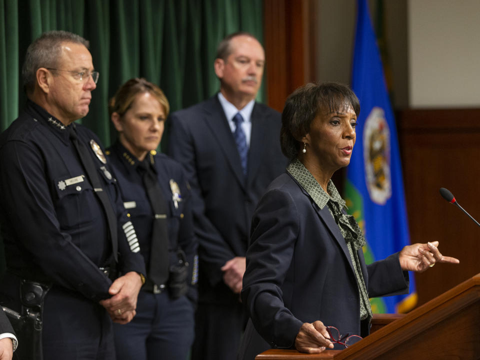 Los Angeles County District Attorney Jackie Lacey, right, at podium, announces that film producer Harvey Weinstein has been charged with raping a woman and sexually assaulting another in separate incidents over a two-day period in 2013, at a news conference at the Hall of Justice in Los Angeles, Monday, Jan. 6, 2020. From left, Michel Moore, Chief of the Los Angeles Police Department, and Sandra Spagnoli, Chief of Police, Beverly Hills, Calif., and Los Angeles County District Attorney's Office's Bureau of Investigation Chief John Neu. (AP Photo/Damian Dovarganes)