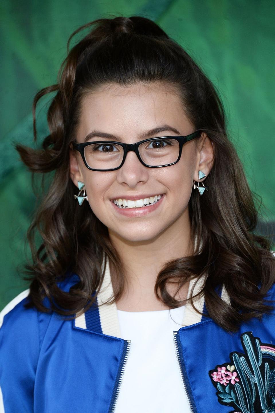 A close-up of a young Madisyn Shipman with glasses
