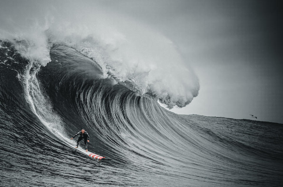 a still from 100 Foot Wave with Garrett McNamara surfing a huge wave