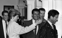 <p>The Princess of Wales smashes an imitation bottle made of sugar glass over the head of the Prince of Wales during the couples visit to the set of <em>The Living Daylights.</em></p>