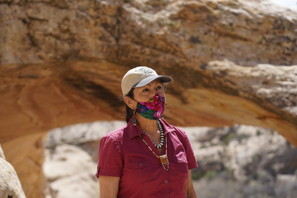 U.S. Interior Secretary Deb Haaland tours near ancient dwellings along the Butler Wash trail during a visit to Bears Ears National Monument Thursday, April 8, 2021, near Blanding, Utah. (AP Photo/Rick Bowmer, Pool)