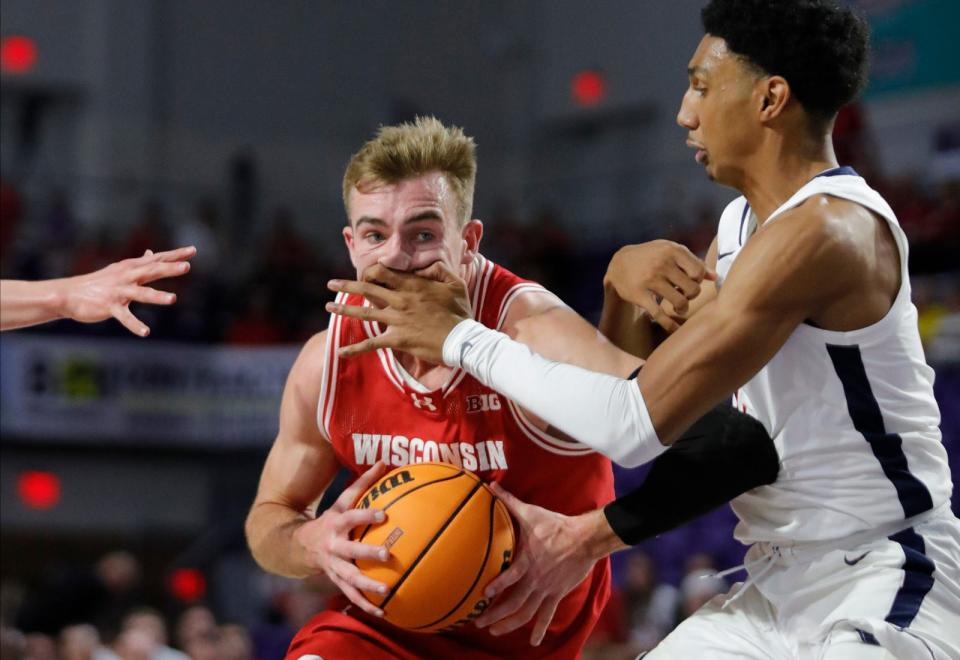 Wisconsin player Tyler Wahl gets fouled by defender Ryan Dunn while driving to the basket. The University of Wisconsin Badgers mens basketball team defeated the University of Virginia Cavaliers as they faced off in the 2023 Fort Myers Tip-Off tournament Monday, November 20, 2023. The Badgers won with a final score of 65-41.