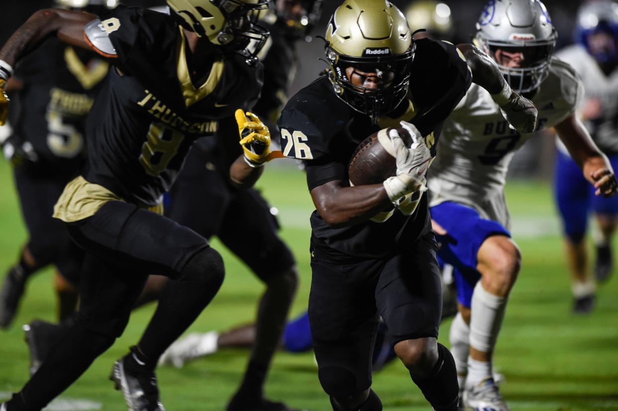 Thomson running back Tre Tre Jefferies (26) moves past defenders during the Thomson and Burke County football game at The Brickyard in Thomson, Ga., on Friday, Aug. 19, 2022. Burke County defeated Thomson 24-21. 