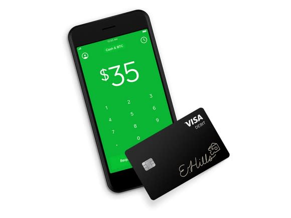 Phone displaying the Cash App, with a Cash Card next to it.