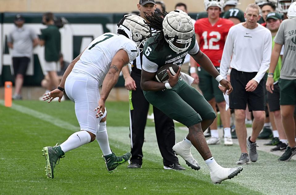 Apr 15, 2023; East Lansing, MI, USA;  Michigan State Spartans tight end Maliq Carr (6) steps out of bounds to stop the clock against linebacker Aaron Brule (7) at Spartan Stadium.