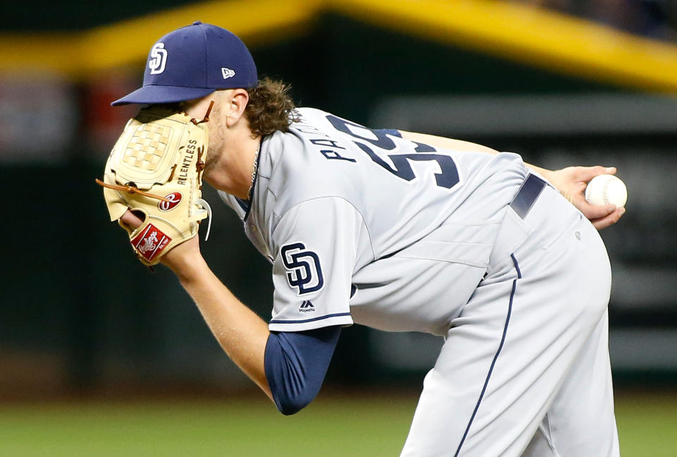 PHOENIX, AZ - APRIL 12:  Starting pitcher Chris Paddack #59 of the San Diego Padres peers in from behind his glove for a sign from catcher Austin Hedges #18 during the fourth inning of an MLB game against the Arizona Diamondbacks at Chase Field on April 12, 2019 in Phoenix, Arizona.  (Photo by Ralph Freso/Getty Images)