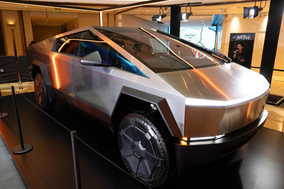 Visitors viewing a Tesla Cybertruck on display in Shanghai, China, on January 31, 2024. (Photo by Costfoto/NurPhoto via Getty Images)