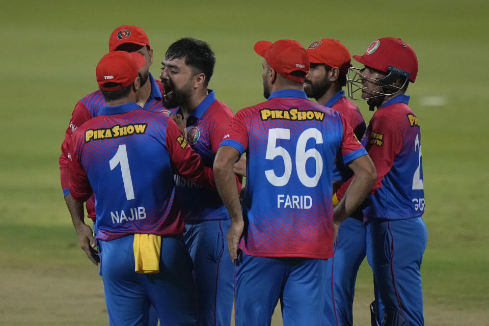 Afghanistan's Rashid Khan, third left, celebrates with teammates the dismissal of Pakistan's Mohammad Rizwan during the T20 cricket match of Asia Cup between Pakistan and Afghanistan, in Sharjah, United Arab Emirates, Wednesday, Sept. 7, 2022. (AP Photo/Anjum Naveed)