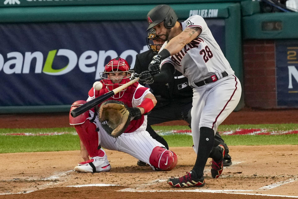 Arizona Diamondbacks' Tommy Pham hits a home run off Philadelphia Phillies starting pitcher Aaron Nola during the second inning in Game 6 of the baseball NL Championship Series in Philadelphia Monday, Oct. 23, 2023.(AP Photo/Matt Rourke)