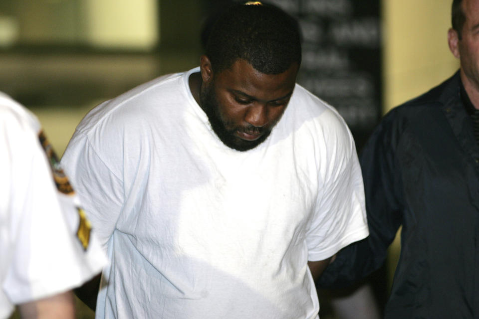 FILE - Onta Williams is led by police officers from a federal building in New York, Thursday, May 21, 2009, after being arrested by the FBI on charges related to a plot to bomb targets in The Bronx section of New York. Four men snared in an infamous post-9/11 terrorism sting were ordered freed from prison Thursday, July 27, 2023, with a judge finding that they had been "hapless, easily manipulated and penurious petty criminals" caught up in a plot driven by an overzealous FBI and a dodgy informant. (AP Photo/Robert Mecea, File)