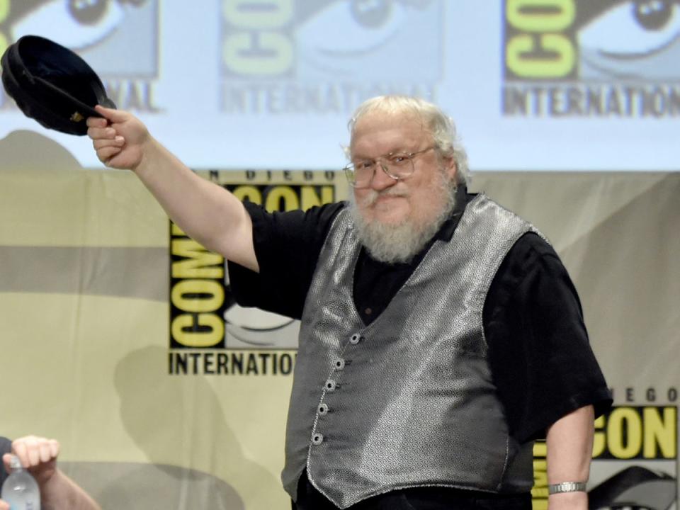 Martin tips his hat to fans at a 2014 Comic Con Q&A (Getty)