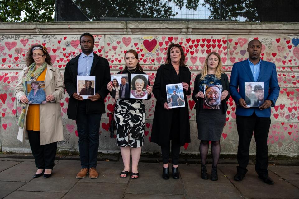 Representatives from Covid-19 Bereaved Families for Justice at the Covid Memorial Wall (Getty)