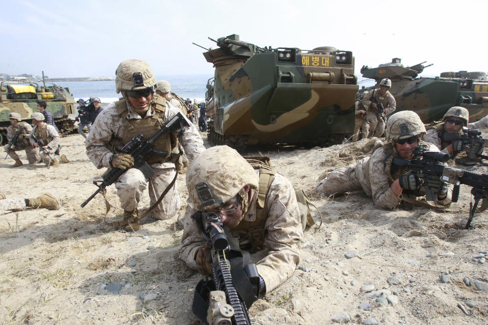 U.S. Marines aim their machine guns during the U.S.-South Korea joint landing exercises called Ssangyong, part of the Foal Eagle military exercises, in Pohang, South Korea, Monday, March 31, 2014. South Korea said North Korea has announced plans to conduct live-fire drills near the rivals' disputed western sea boundary. The planned drills Monday come after an increase in threatening rhetoric from Pyongyang and a series of rocket and ballistic missile launches in an apparent protest against the annual military exercises by Seoul and Washington. (AP Photo/Ahn Young-joon)