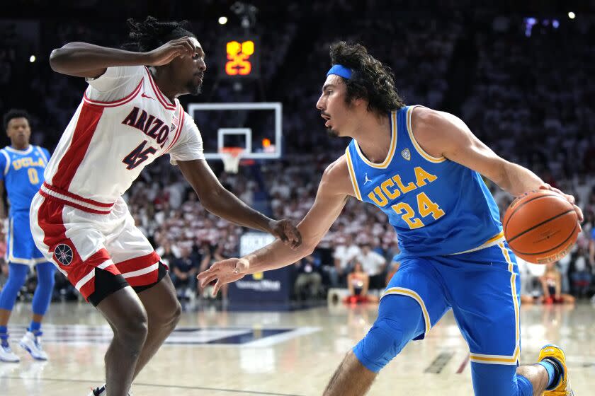 UCLA guard Jaime Jaquez Jr. dribbles in front of Arizona guard Cedric Henderson Jr.