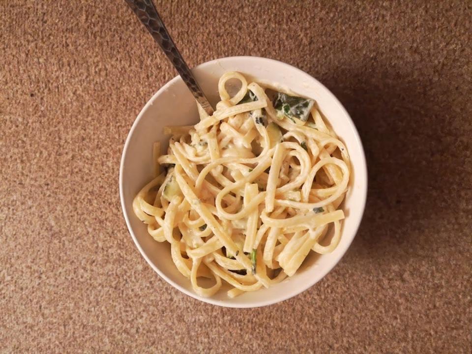 A bowl of spaghetti with a fork in it