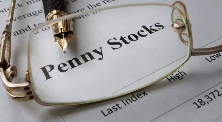 Glasses viewing penny stocks on a piece of paper