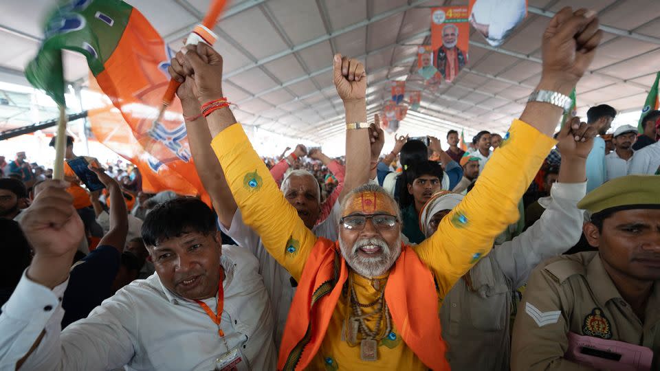 Supporters wave the flag of Prime Minister Narendra Modi's Bharatiya Janata Party (BJP) in Aligarh, India, on April 22, 20224. - John Mees/CNN