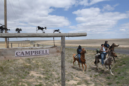 The Fort Laramie treaty riders pass by a sign post displaying the name of a ranch in Torrington, Wyoming, U.S., April 26, 2018. REUTERS/Stephanie Keith