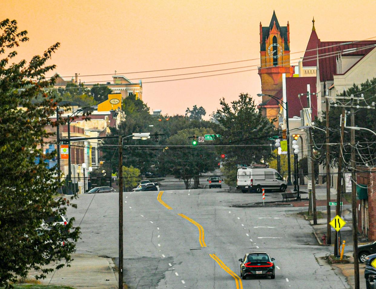 The Historic Anderson County Courthouse, right, with county offices, stands tall near city hall, far right, and storefronts, left, in downtown Anderson, S.C., October 2021. 