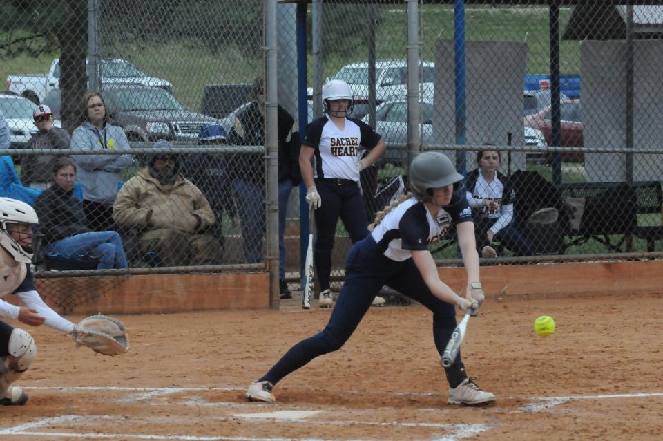 Sacred Heart's Ellie Woodall (10)  swings at a pitch during a doubleheader against Wichita Trinity Tuesday, May 3, 2022, at Bill Burke Park.