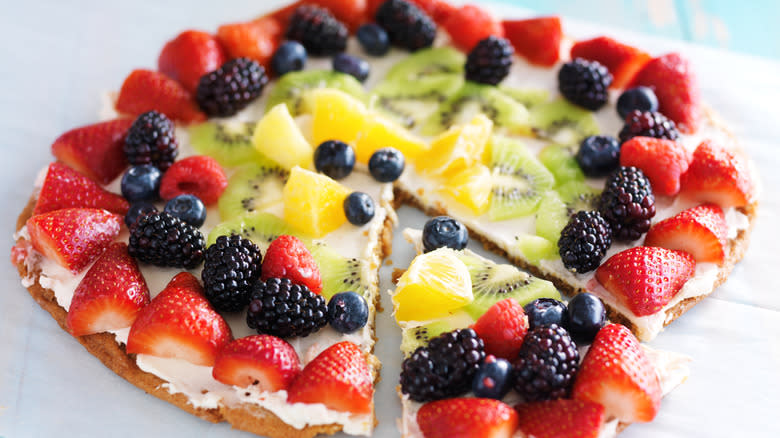 Fruit pizza with slice 