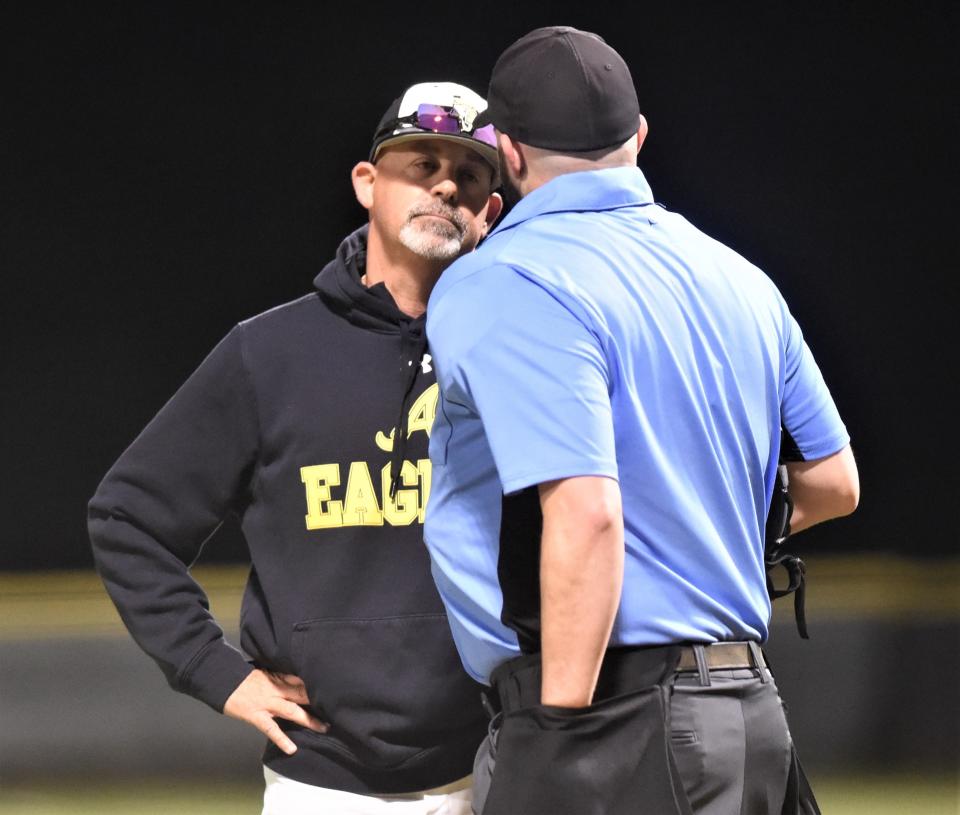 Abilene High coach Brad Harman, left, listens to the umpire after ejected for arguing a call in the top of the sixth inning against Wylie.