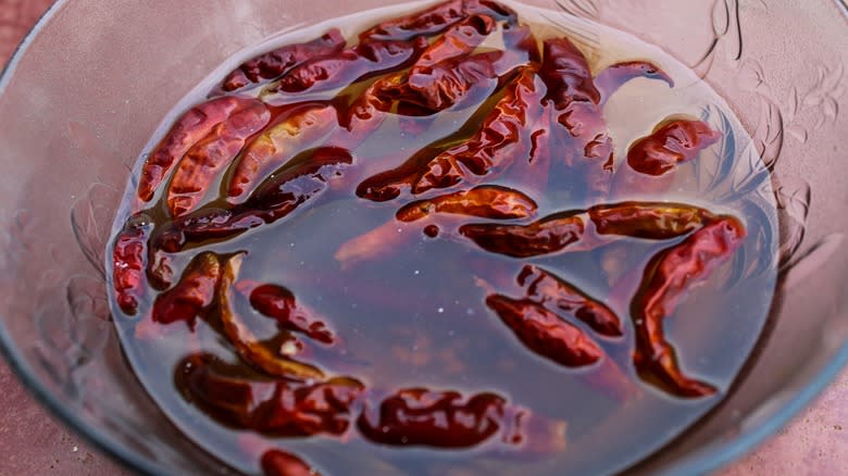chilies soaking in glass bowl