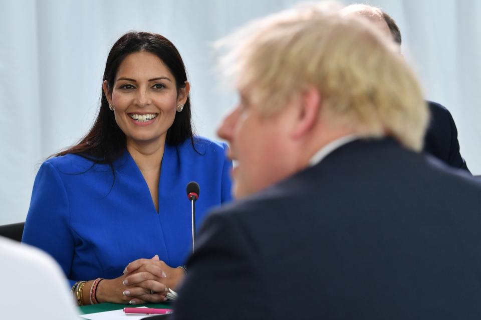 Home Secretary Priti Patel (L) looks on Britain's Prime Minister Boris Johnson chairs a cabinet meeting at the National Glass Centre (Getty Images)