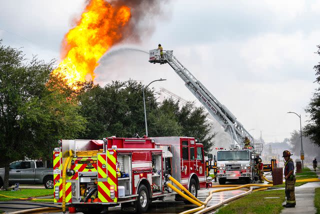 <p>Brett Coomer/Houston Chronicle via Getty</p> Firefighters protect a neighborhood from a fire in a pipeline carrying liquified natural gas burns near Spencer Highway and Summerton on Monday, Sept. 16, 2024 in La Porte. The fire caused road closures and shelter-in-place advisories Monday afternoon in the area, with evacuations to homes and businesses within a half mile from the fire site.