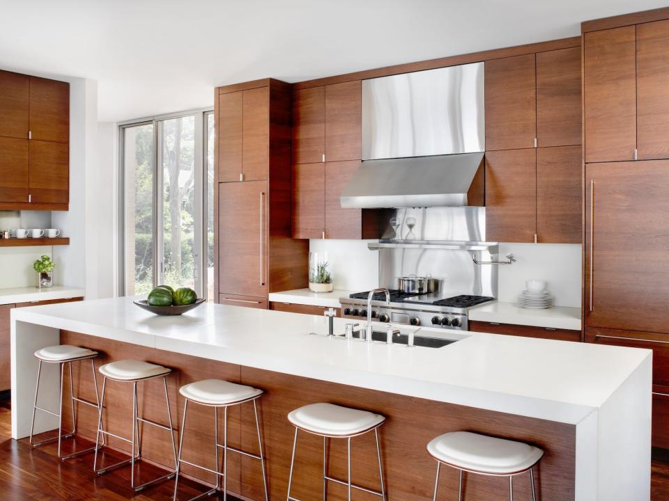 A luxury kitchen with dark cabinetry and a large island.