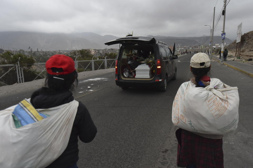 A coffin carrying the remains of Jhan Carlos Condori Arcana is driven to his wake in Arequipa, Peru, Friday, Jan. 20, 2023. According to local media, Arcana was a protester who was killed the previous day during clashes with police. Protesters are seeking immediate elections, President Dina Boluarte's resignation, the release of ousted President Pedro Castillo and justice for up to 48 protesters killed in clashes with police. (AP Photo/Jose Sotomayor)