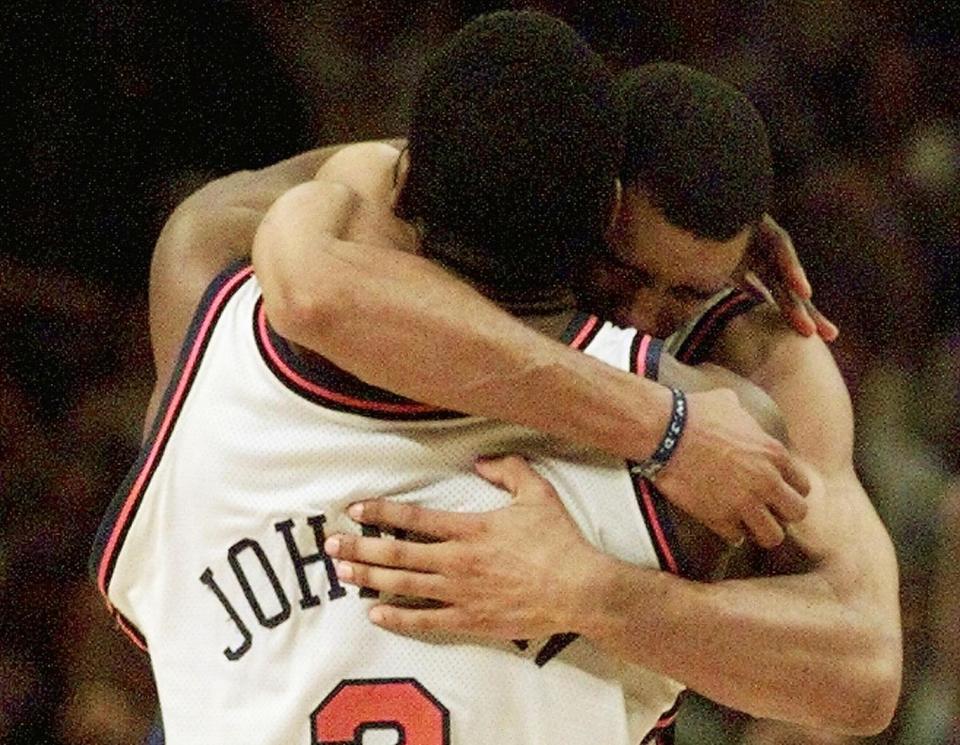 Knicks forward Larry Johnson hugs teammate Allan Houston after his iconic four-point play. (Jeff Haynes/AFP via Getty Images)