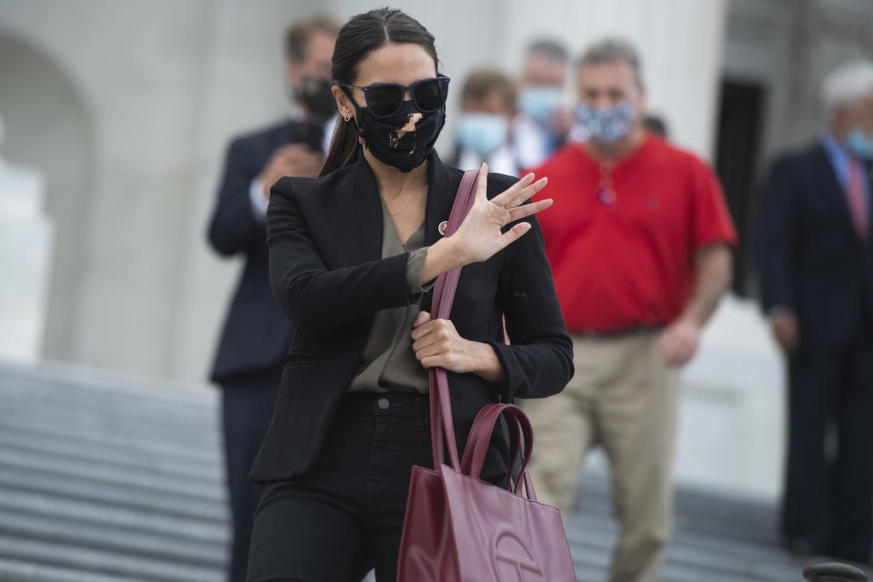 UNITED STATES - AUGUST 22: Rep. Alexandria Ocasio-Cortez, D-N.Y., leaves the Capitol as the House voted on a bill to ban changes to U.S. Postal Service operations and provide $25 billion in funding on Saturday August 22, 2020. Rep. Roger Williams, R-Texas, appears at left. (Photo By Tom Williams/CQ-Roll Call, Inc via Getty Images)