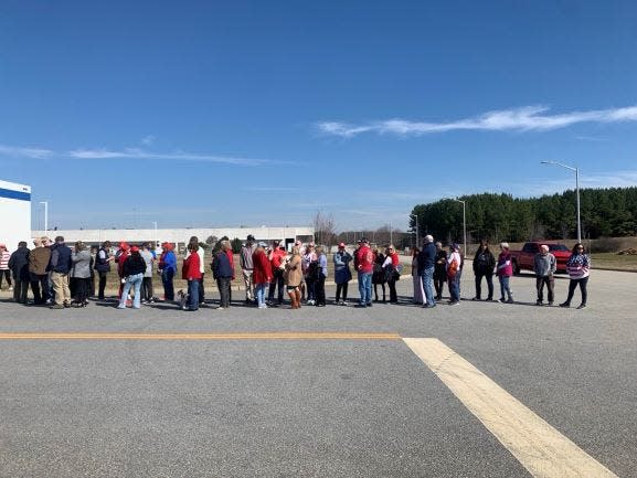 Roughly one hundred individuals, many dressed in red, white and blue and Trump attire, are gathered outside of the Greenville-Spartanburg International airport. Trump is expected to land in approximately two hours.