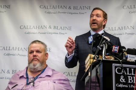 Geoffrey Johnson, left, and his attorney Daniel J. Callahan speak in a news conference announcing a lawsuit against his former lawyer Michael Avenatti over a 4 million dollar settlement with the County of Los Angeles in Santa Ana
