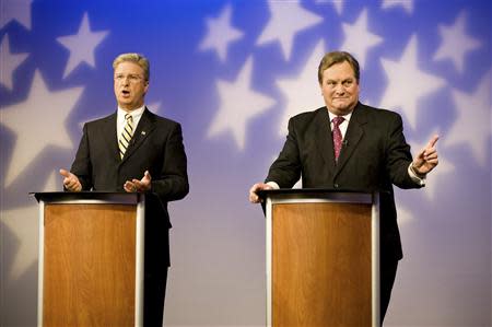 Challenger Bryan Smith (L) and incumbent Congressman Mike Simpson (R-ID) participate in a televised debate for the upcoming Republican primary election at the studios of Idaho Public Television in Boise, Idaho May 11, 2014. REUTERS/Patrick Sweeney